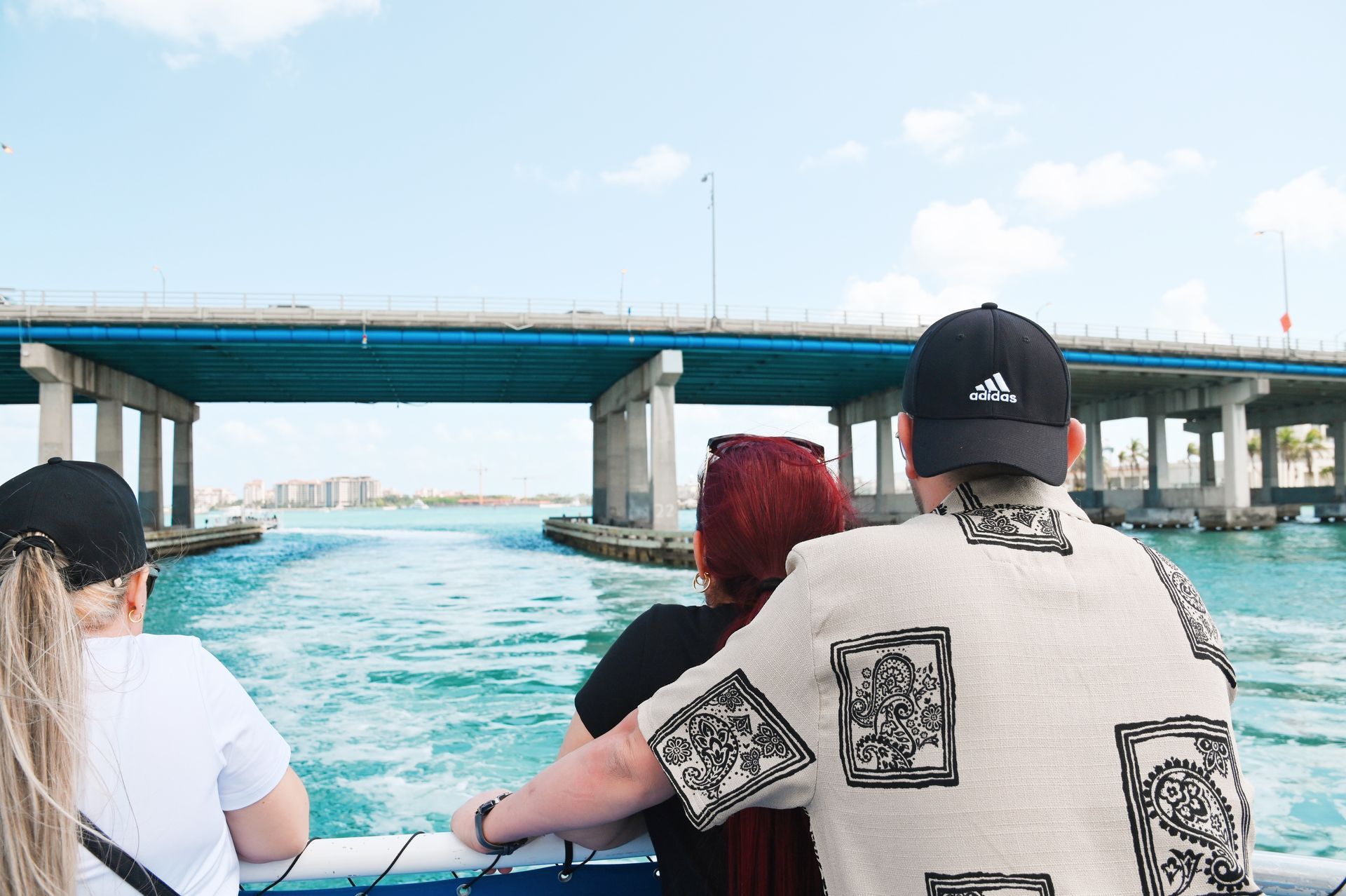 Miami boat cruise passengers looking at the Douglas MacArthur Causeway bridge