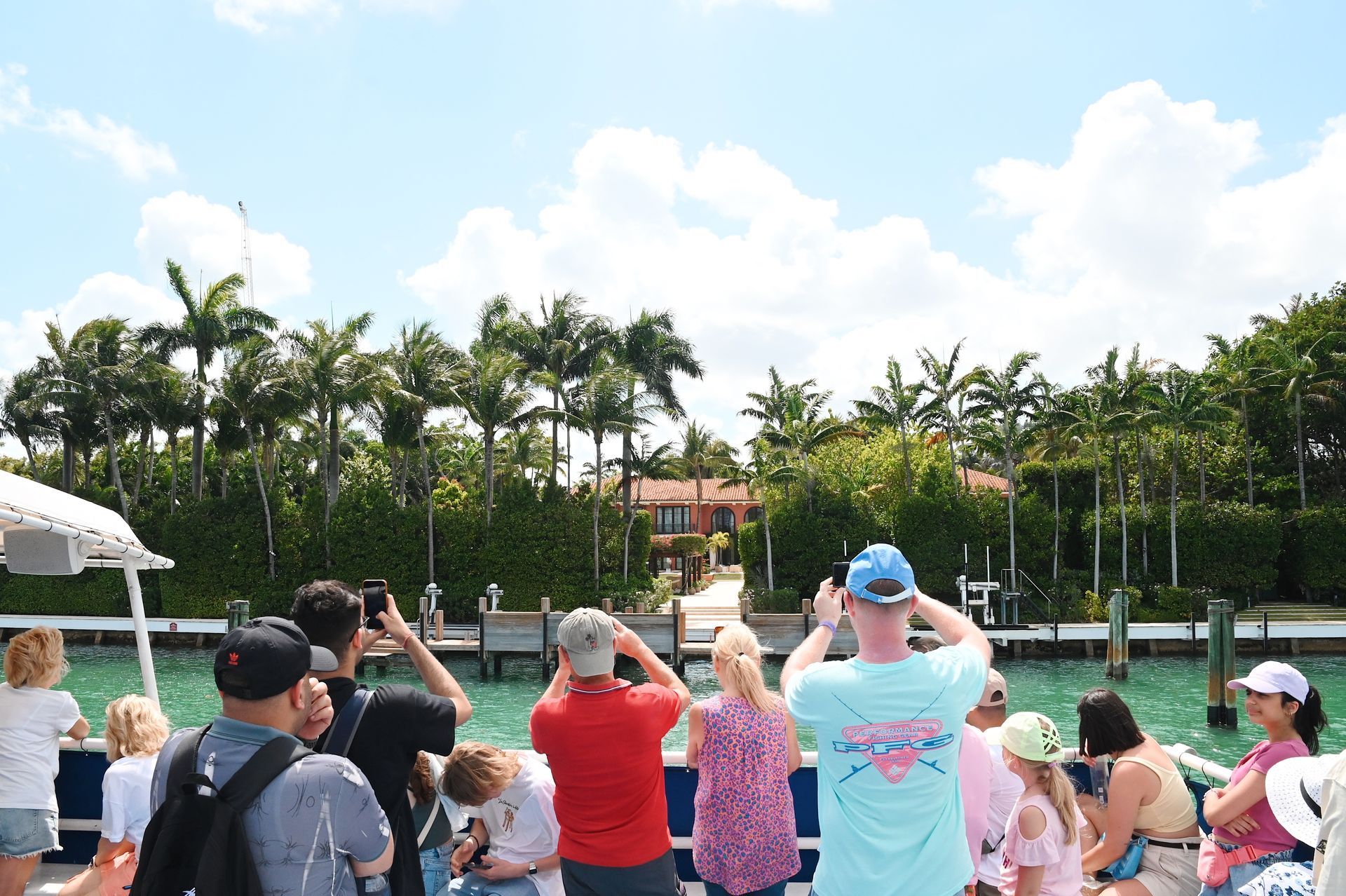 Miami boat tour passengers taking photos of Shaq Mansion in Star Island