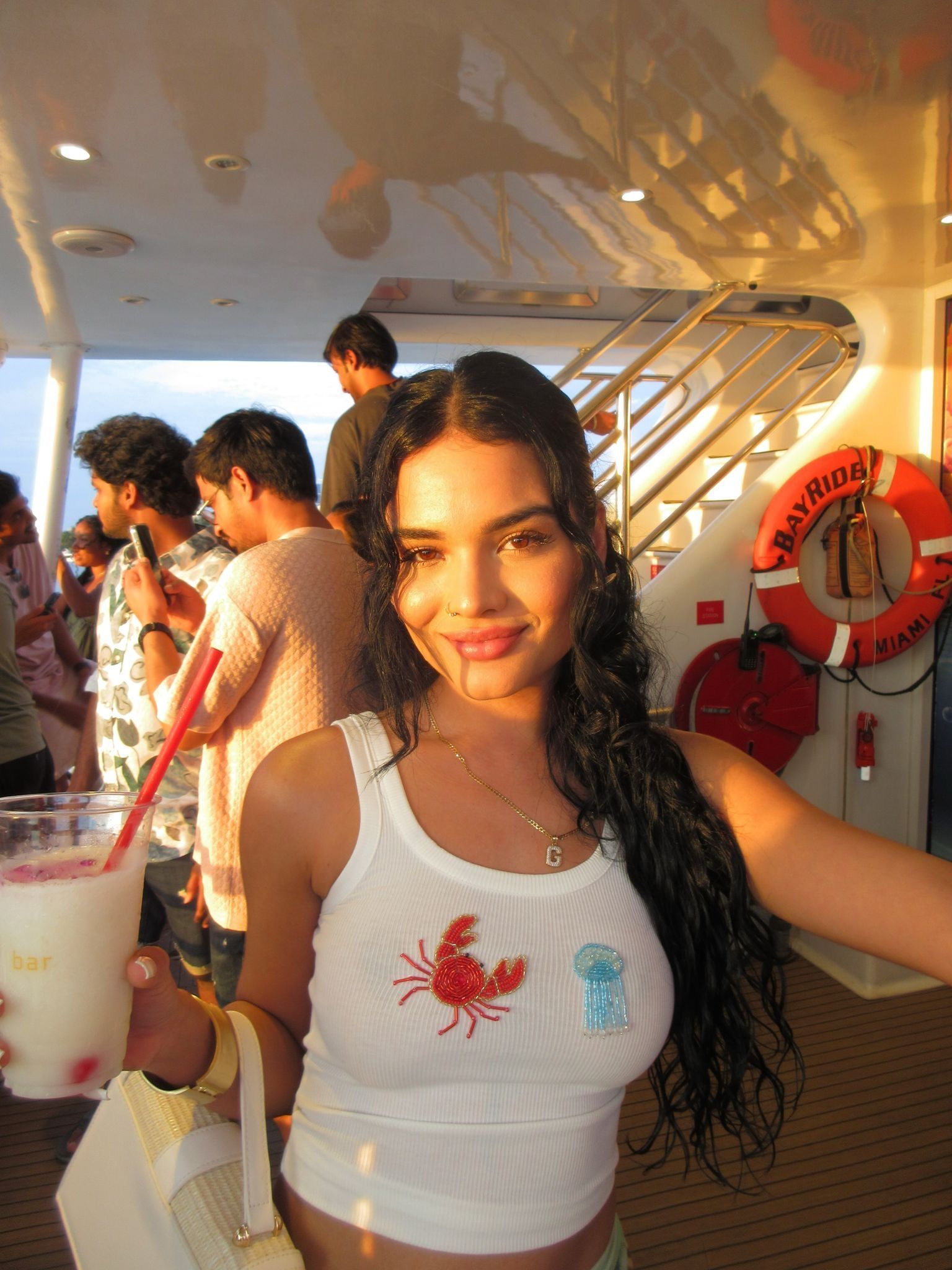 Woman with a Mojito on deck using Bayside Boat Tours promo codes during a Miami boat tour