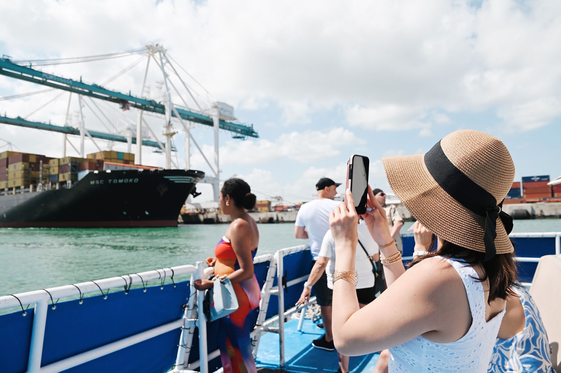 Miami Sightseeing Boat tour passing by the Port of Miami, passengers taking photos 