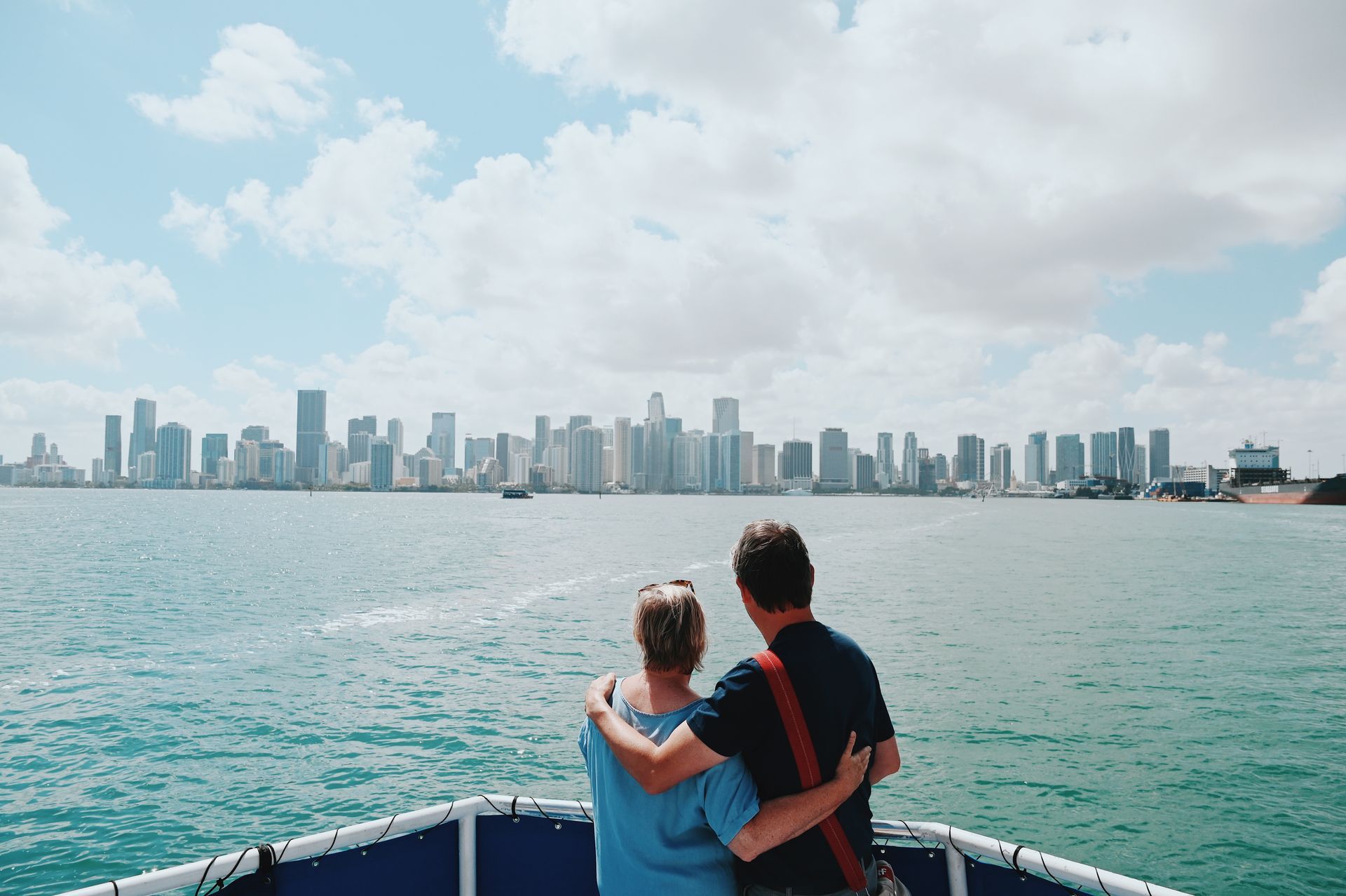 Couple enjoying breathtaking views of the Miami skyline from a boat during one of the scenic Miami Tours on Biscayne Bay.