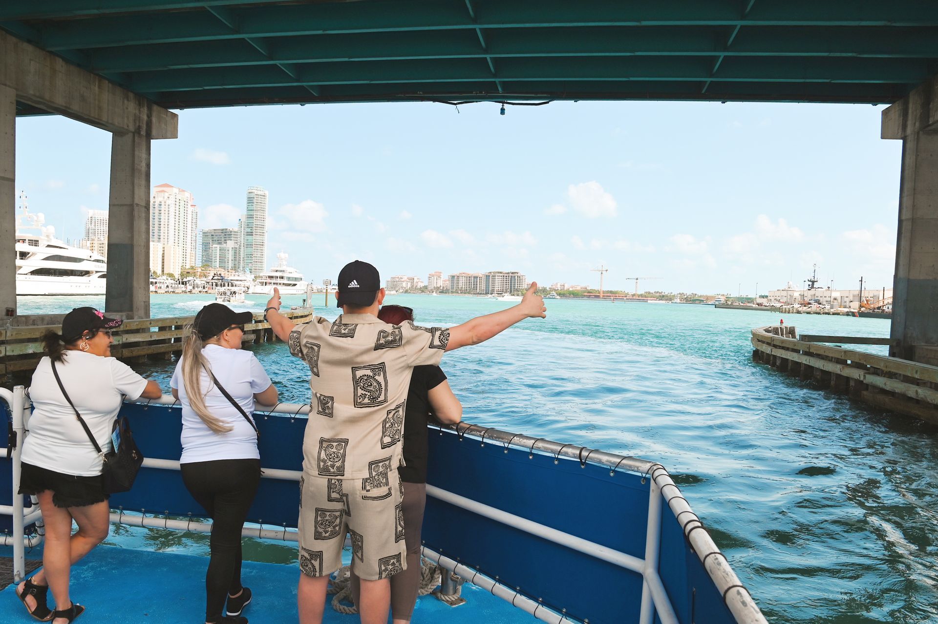Miami Boat tour passengers in front of the boat posing for photos