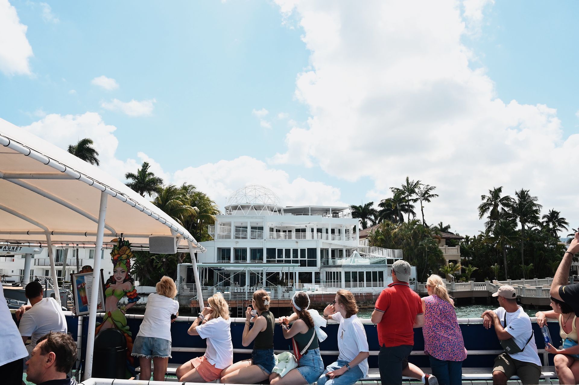 Best Miami Top water tours the Miami Boat tour passing by Star Island and guest looking at the mansions