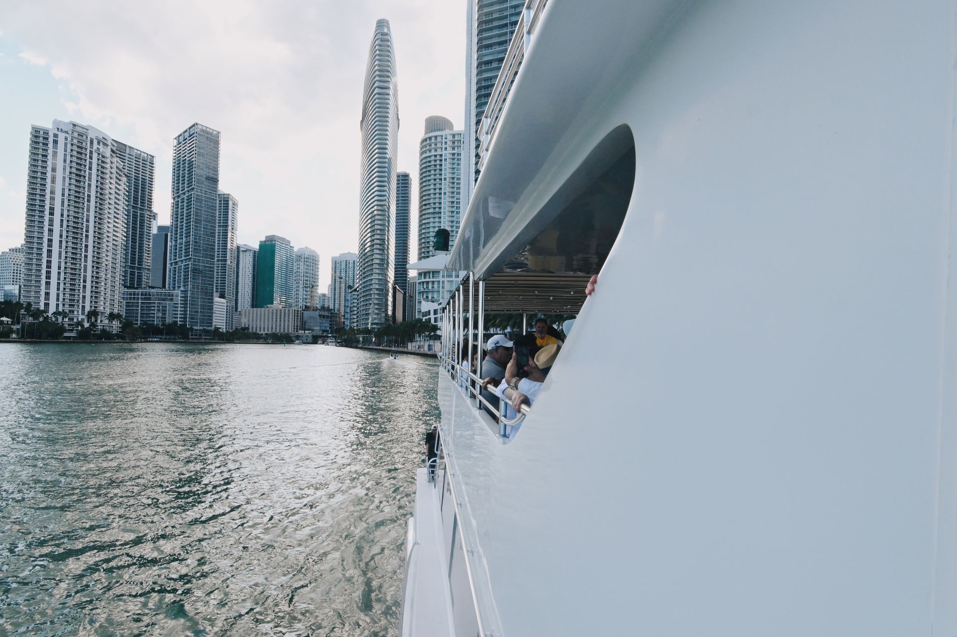 Side view of the Bayride boat with the Miami skyline in the background during a Bayside sightseeing cruise