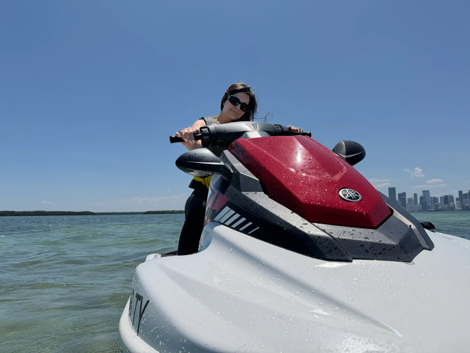 Guest enjoying a Jet Ski Rental Miami experience on Biscayne Bay with the Downtown Miami skyline in the distance
