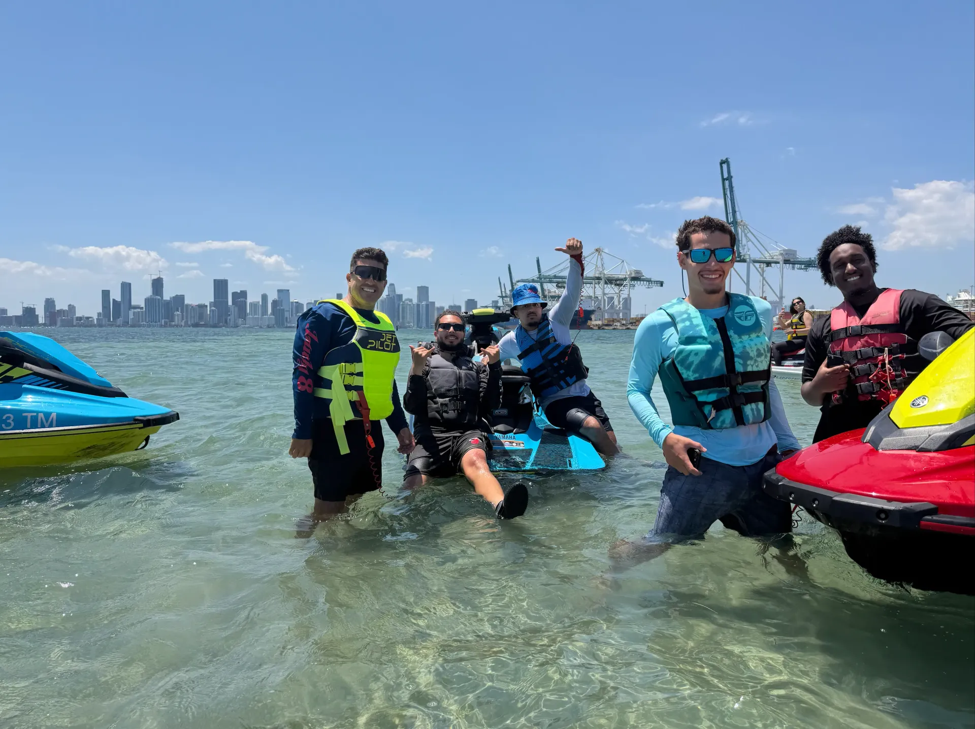 Guests enjoying Miami jet ski rides and rentals at the Fisher Island Sandbar with the Downtown Miami skyline in the background