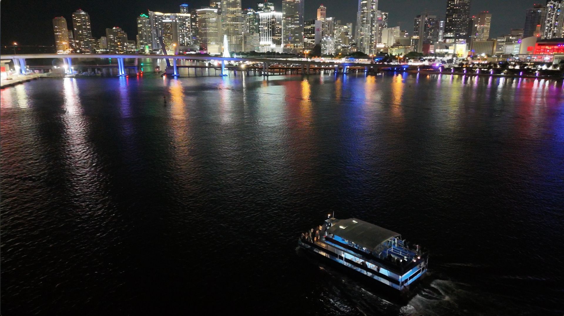 Miami night tour cruising past the Downtown Miami skyline at night on Biscayne Bay.
