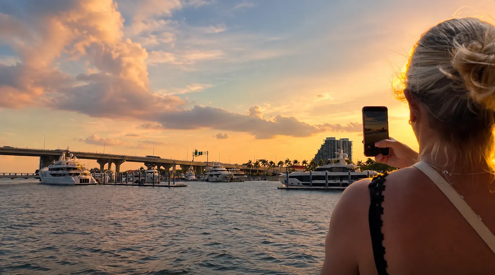 Guest taking photos during a Miami Sunset Sightseeing Cruise while exploring Biscayne Bay and Miami's waterfront.