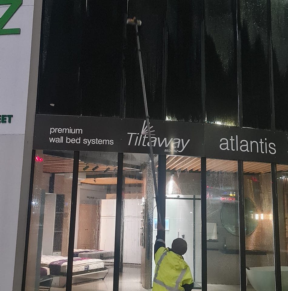 A Man Is Cleaning a Building - Auckland, NZ - Auckland Wash & Go Limited