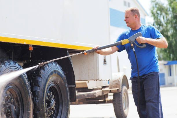 A Man Is Washing a Truck with A High Pressure Washer - Auckland, NZ - Auckland Wash & Go Limited