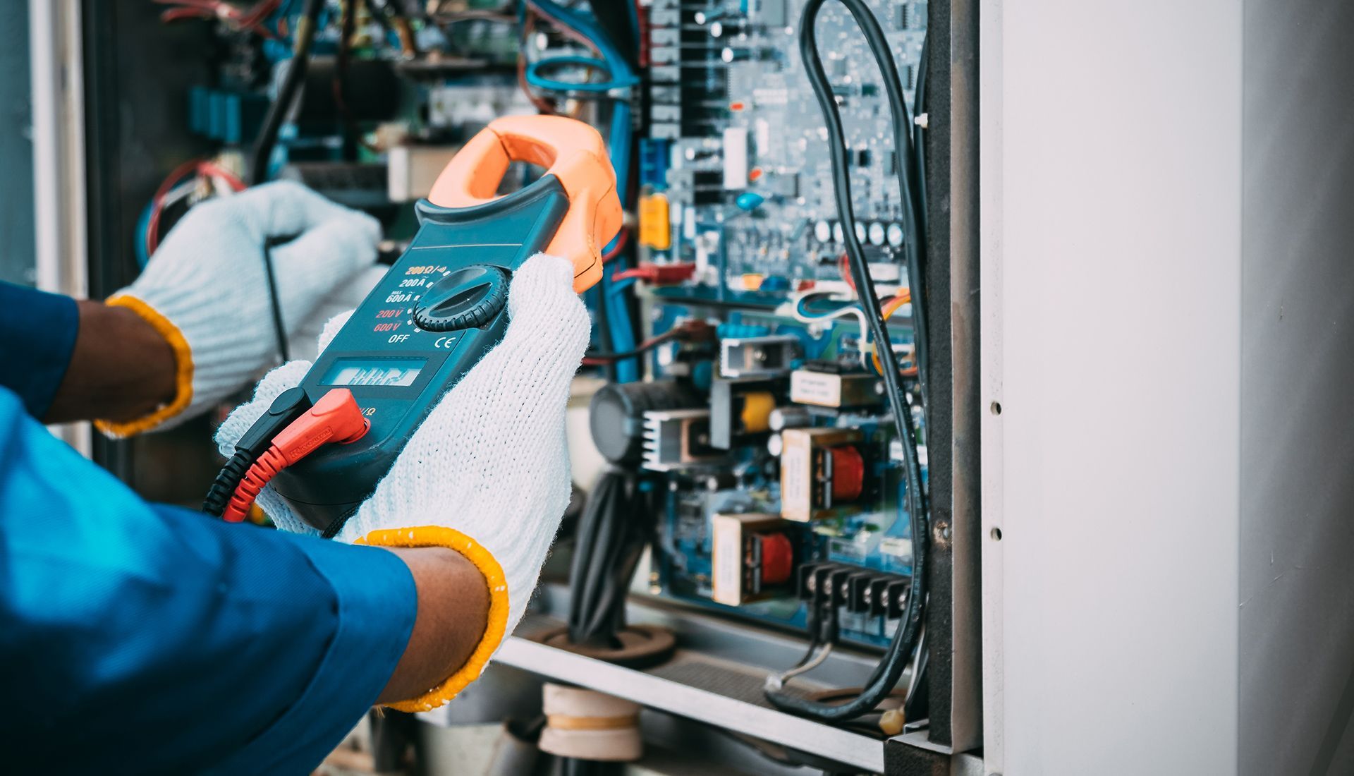 Two men are painting a wall in a room.