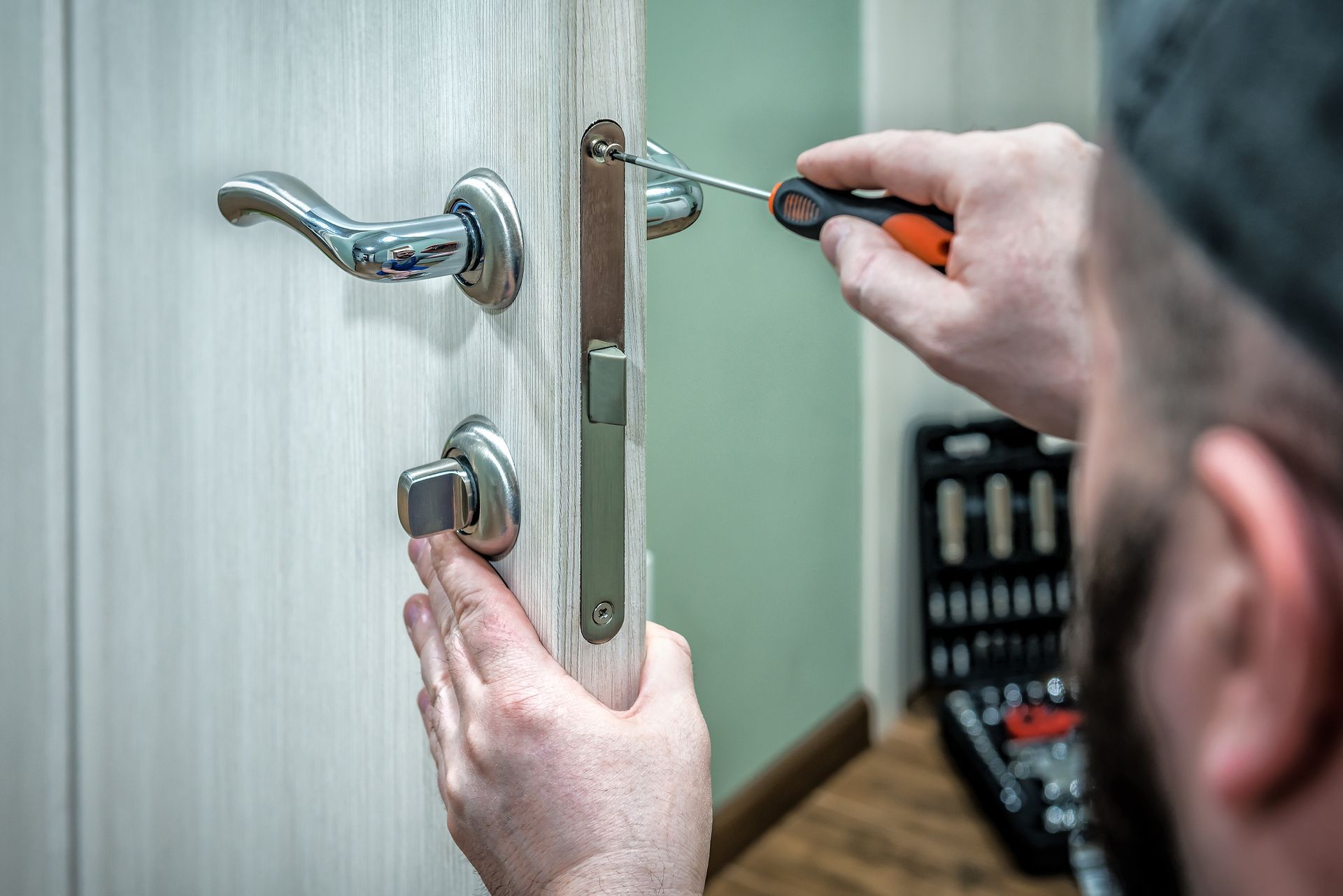 Skilled technician fixing door lock, representing quality residential locksmith service.