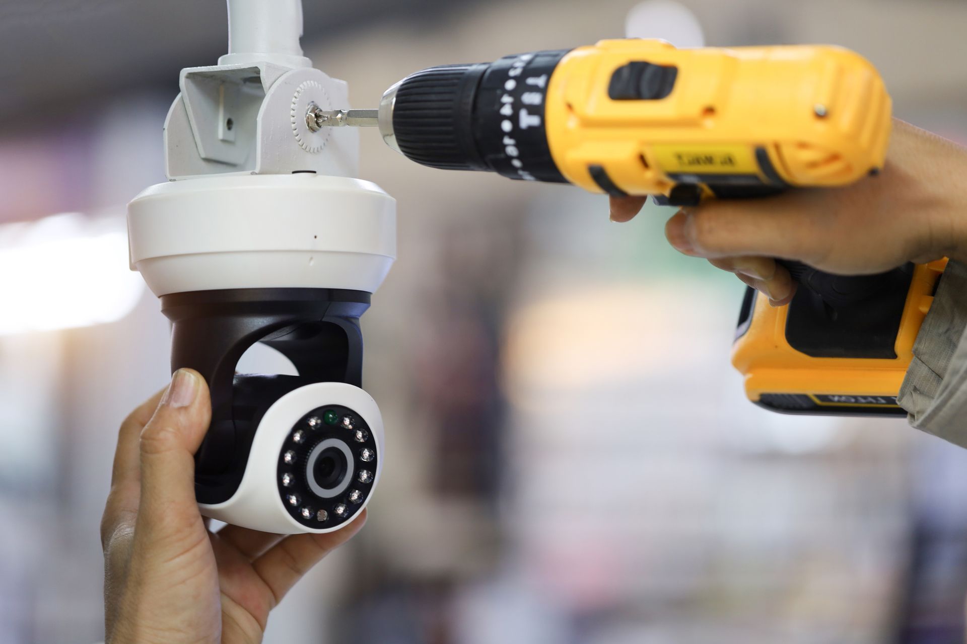 A man is installing a CCTV system.