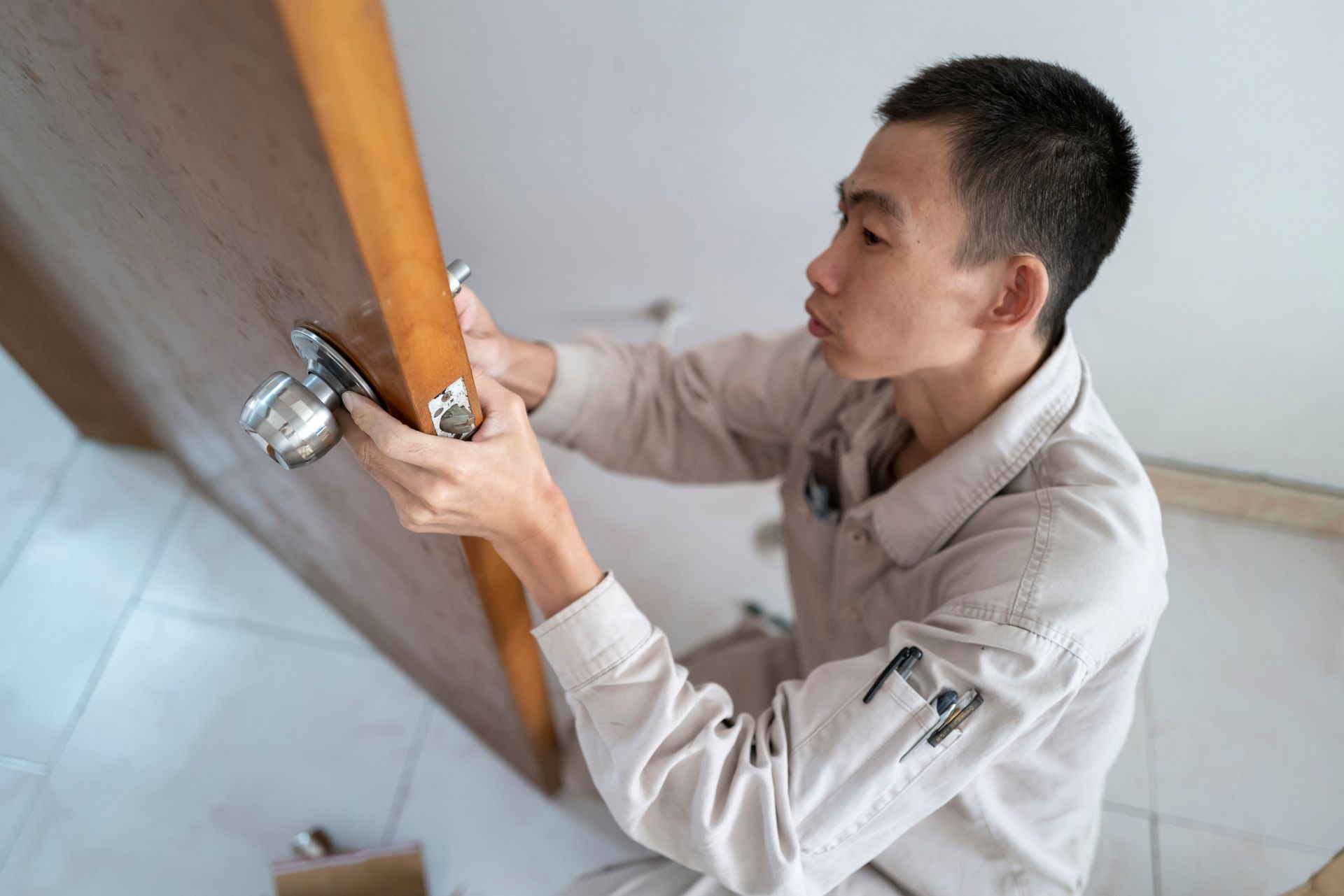 A man is changing the door lock.