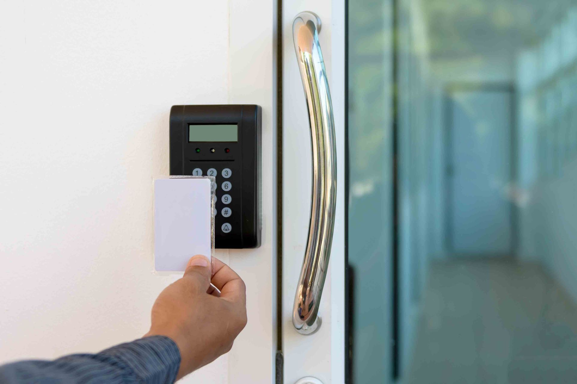 A person holds a card to a door, showcasing A-A Lock & Alarm Inc's commercial locksmith services