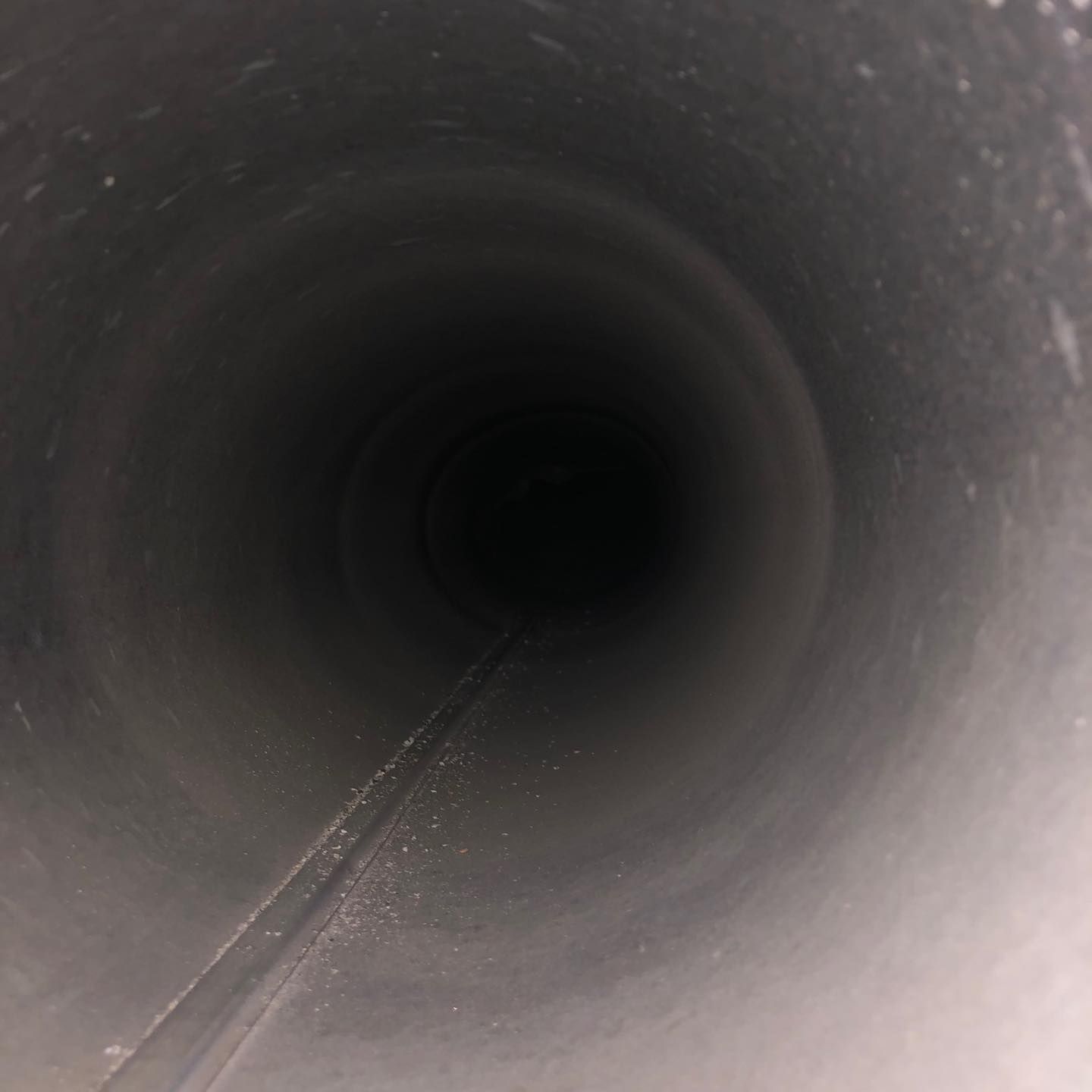 Looking inside a dark, cylindrical metal pipe.