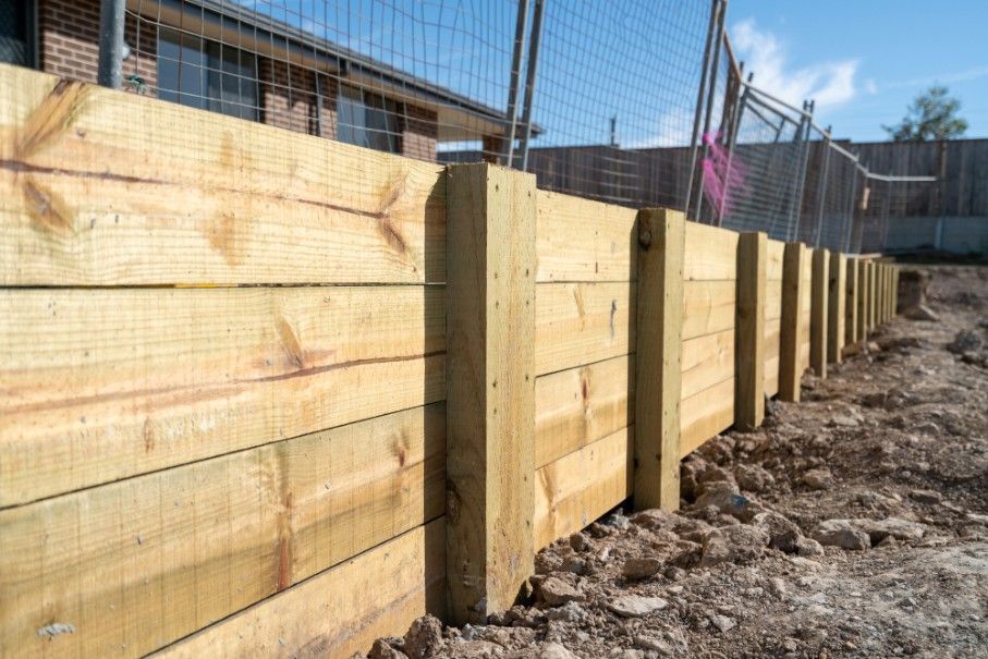 A Wooden Fence is Being Built Next to a Fence — Harbour Fencing In Moonee Beach, NSW