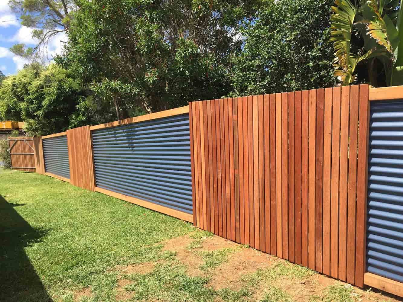 A Wooden Fence With a Metal Fence in the Backyard — Harbour Fencing In Moonee Beach, NSW