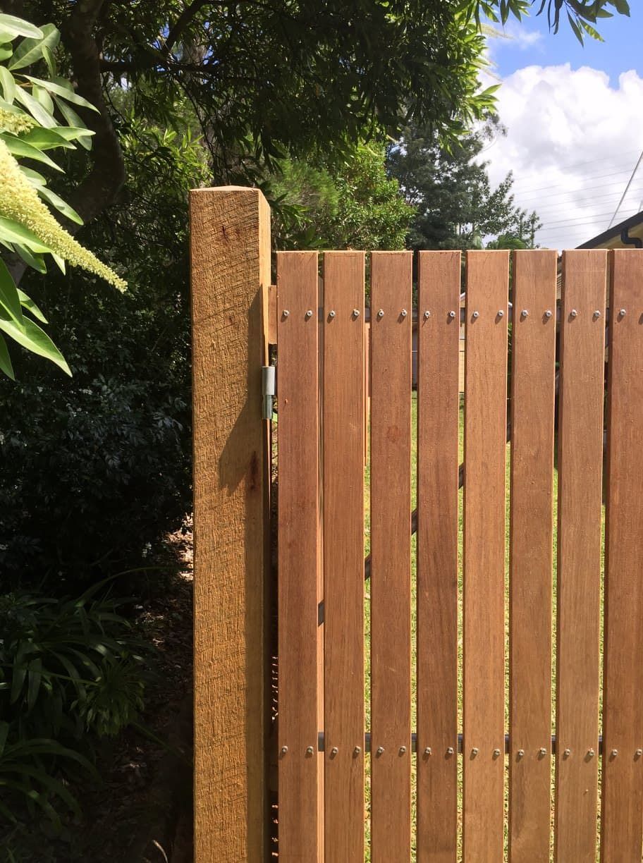 A Close Up of a Wooden Fence With Trees in the Background — Harbour Fencing In Moonee Beach, NSW