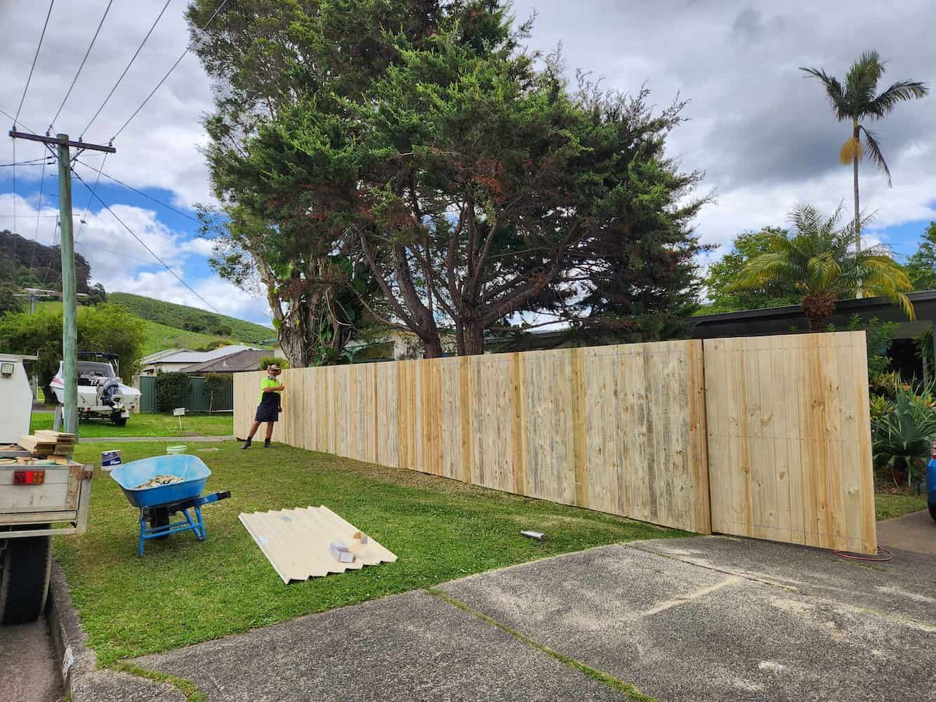 A Wooden Fence is Being Built in the Backyard of a House — Harbour Fencing In Moonee Beach, NSW