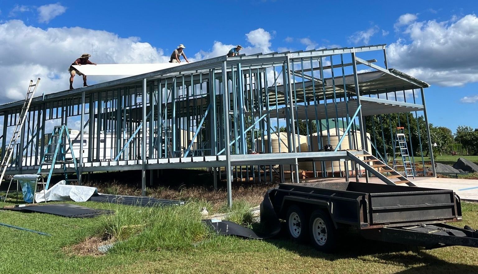 Steel frame of a building under construction against a cloudy sunset — Steel Homes Australia in Branyan, QLD