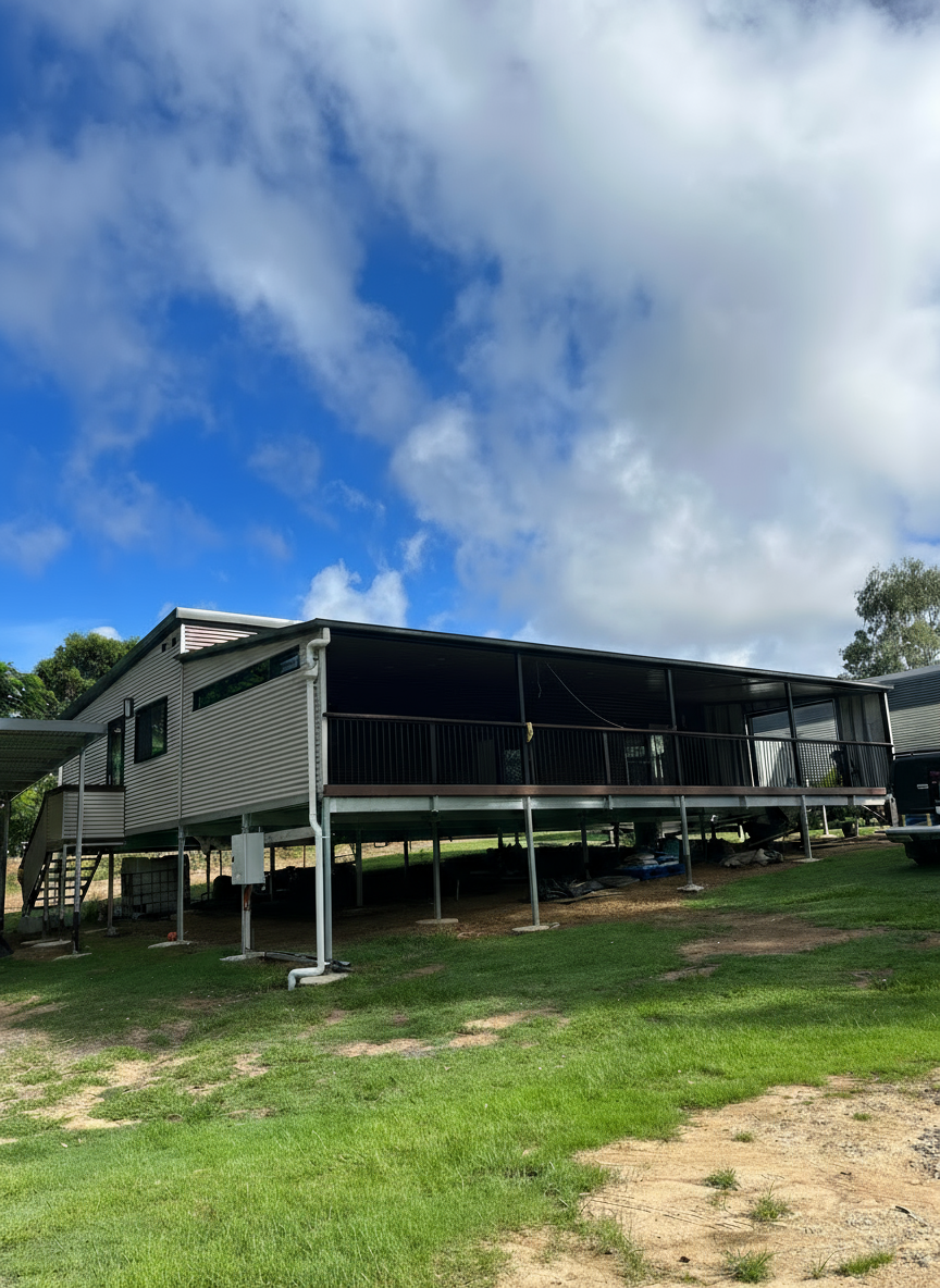 Elevated gray house with large deck, metal roof — Steel Homes Australia in Branyan, QLD