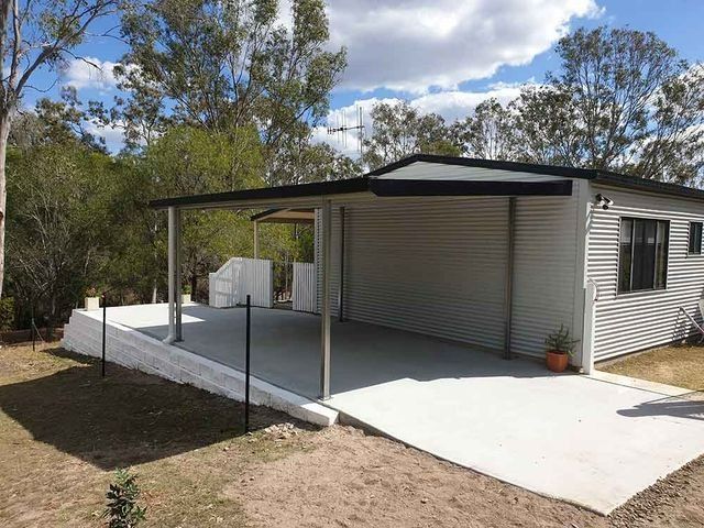 A Small House With a Carport and a Covered Porch — Steel Homes Australia in Branyan, QLD