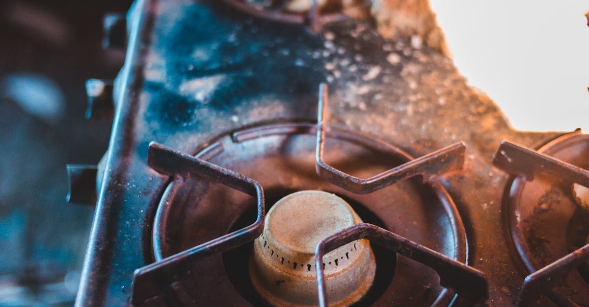 A close up of a gas stove with a light on it.