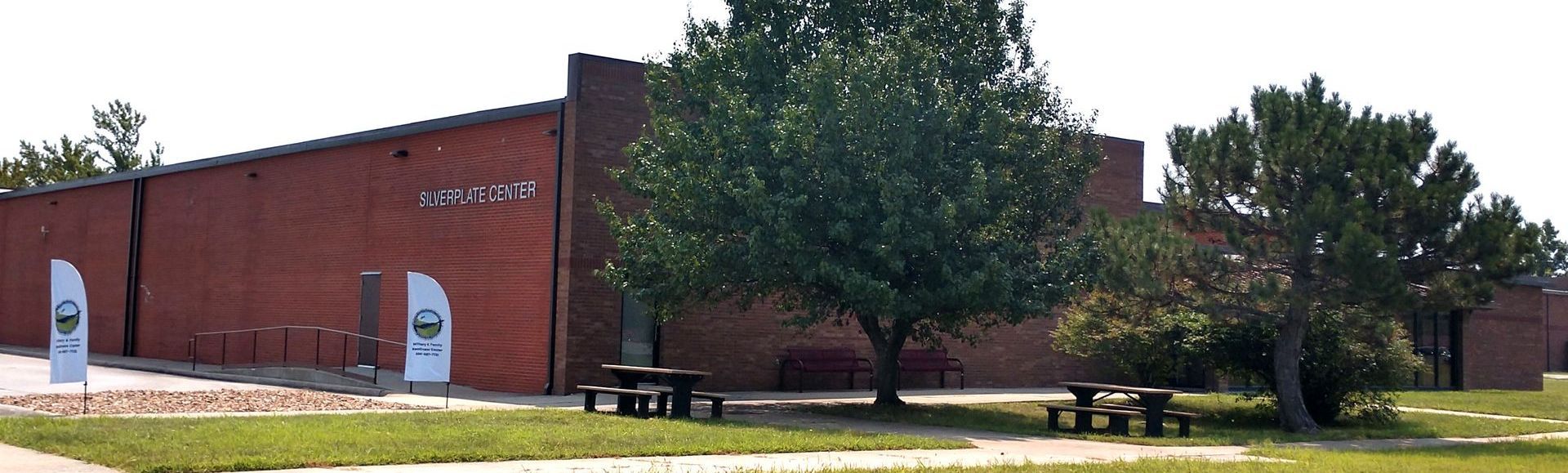 A large red building with a picnic table in front of it