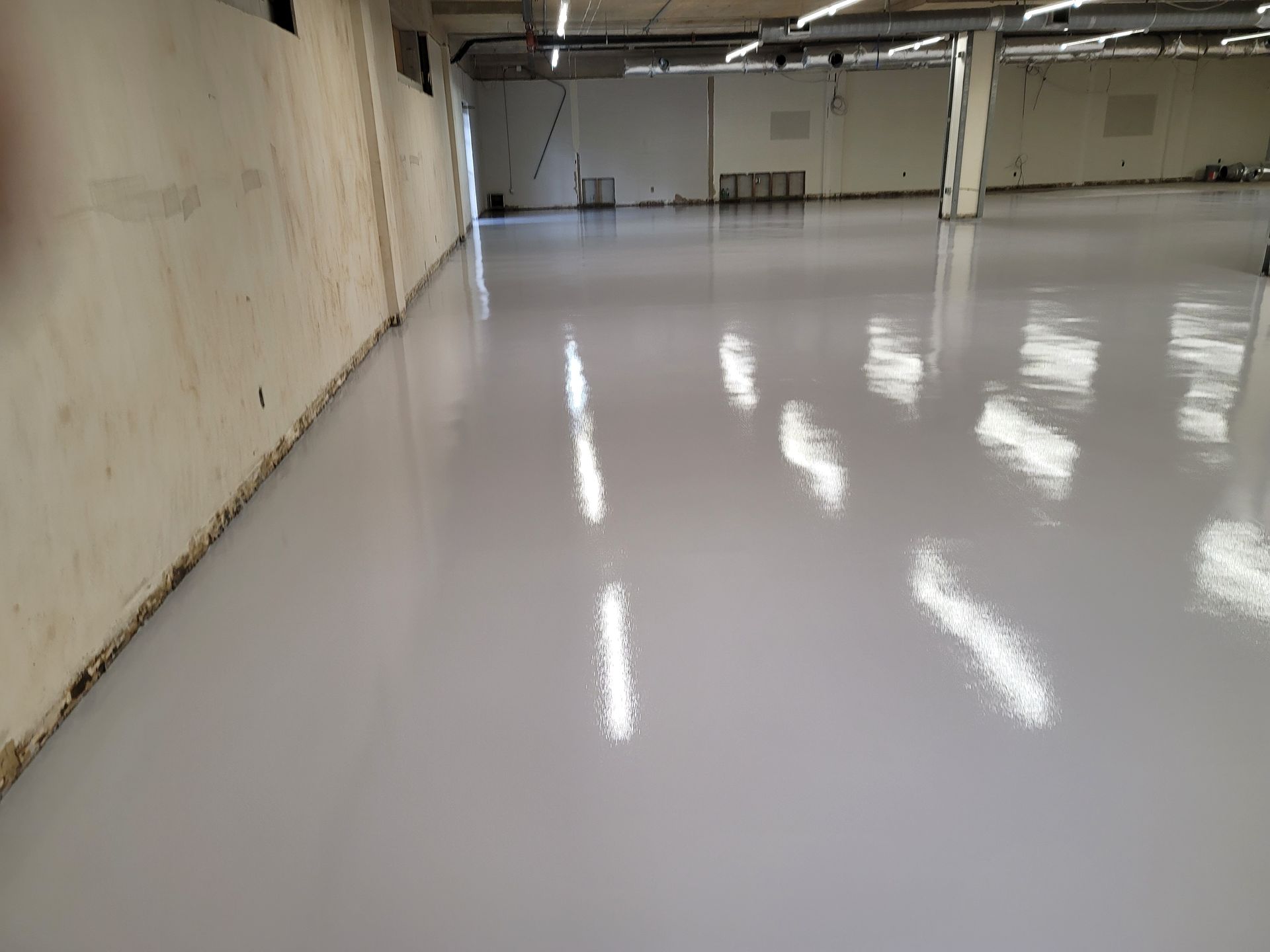 A brown and tan checkered floor with a white fence in the background