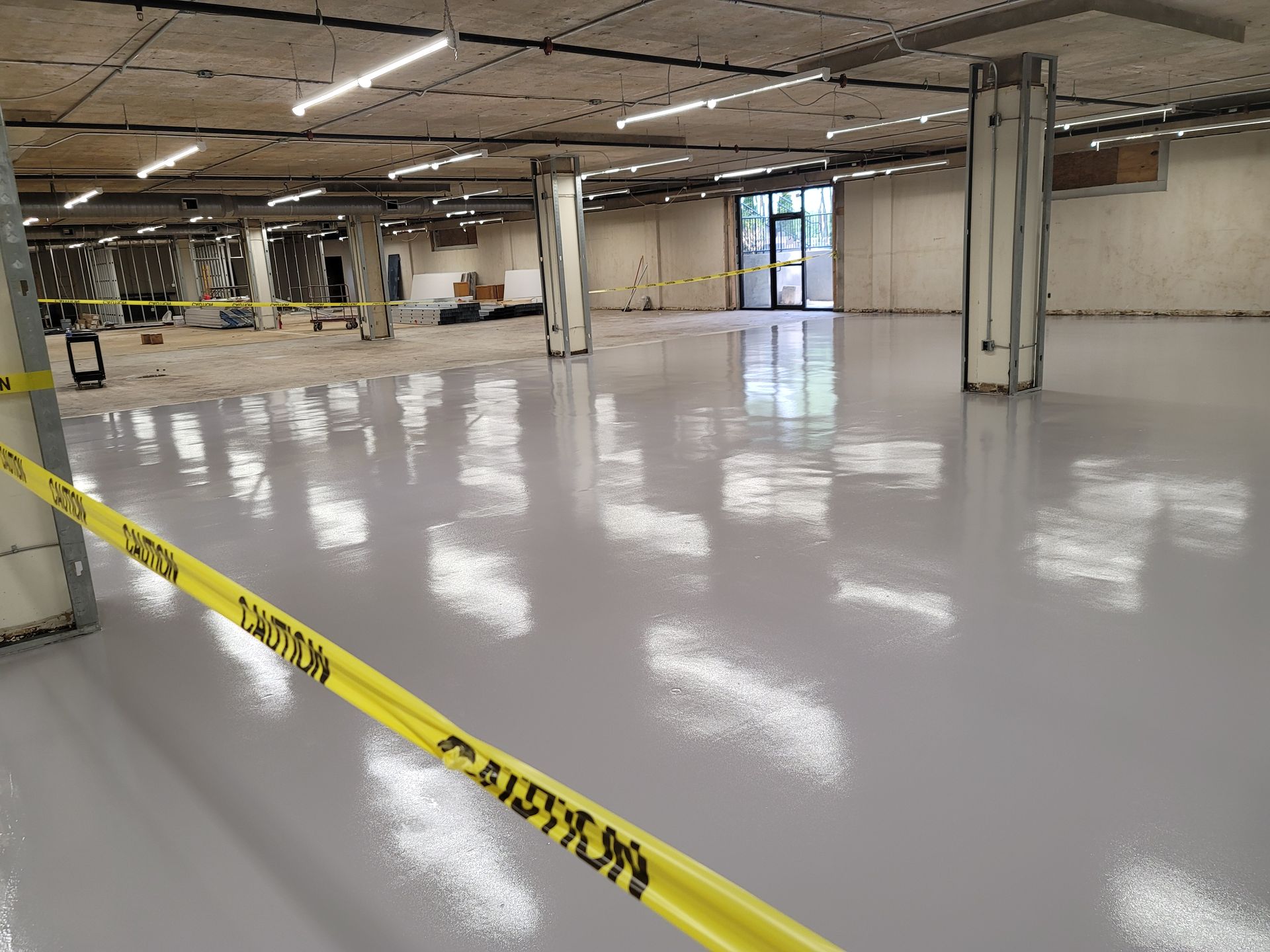 A large concrete floor with a brick wall in the background.