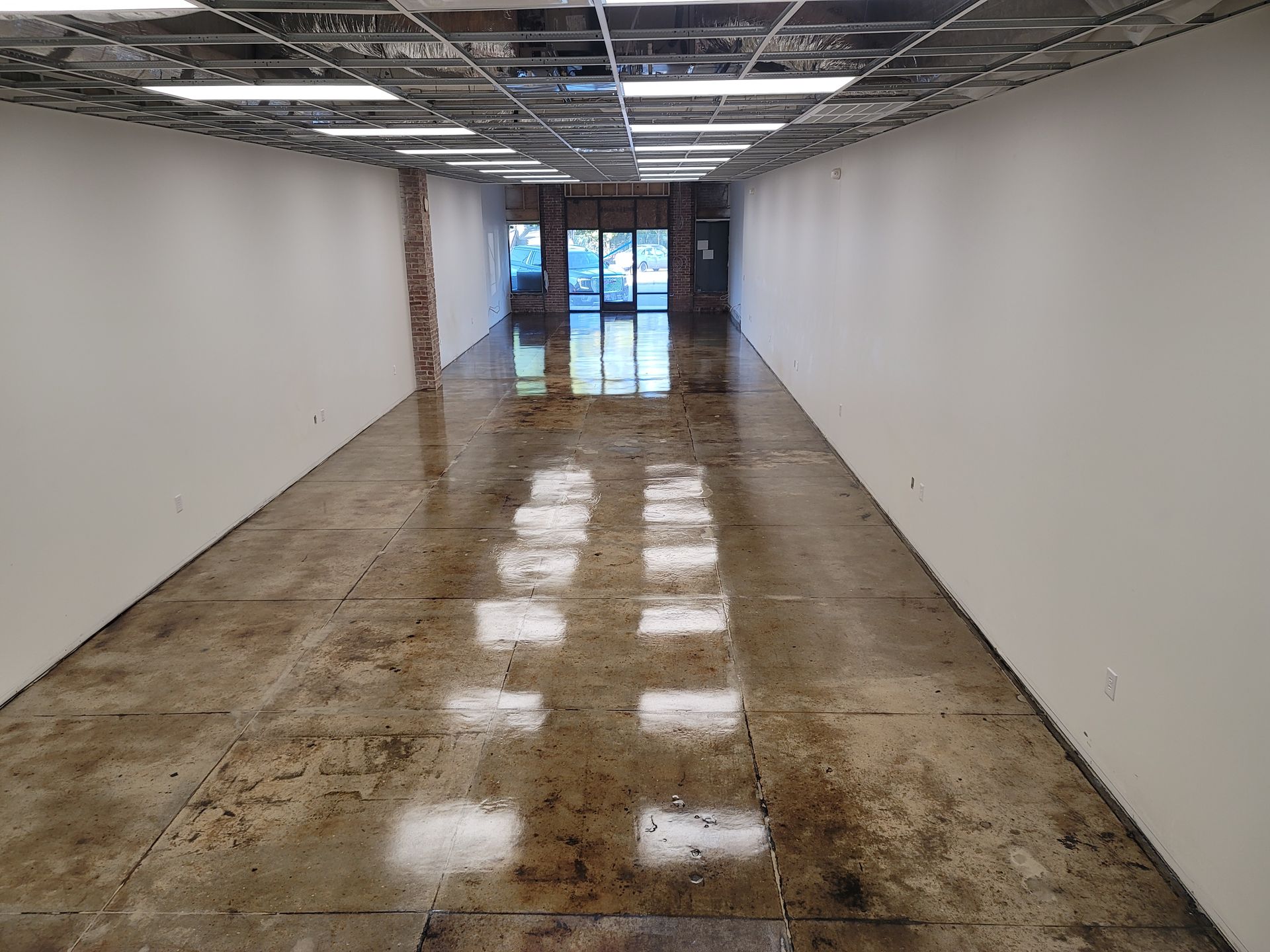 A brown and tan checkered floor with a white fence in the background