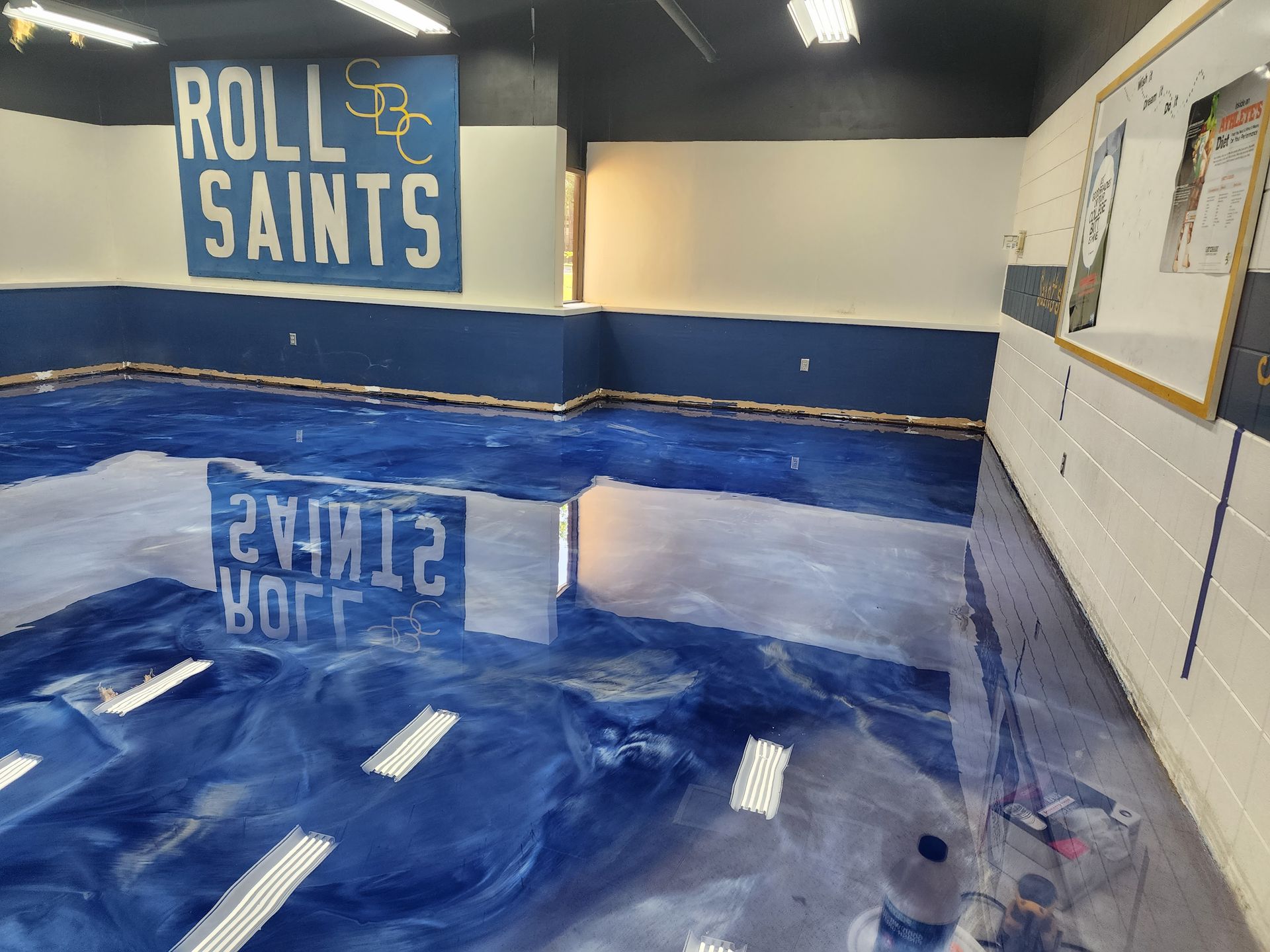 A room with a glossy blue floor reflecting