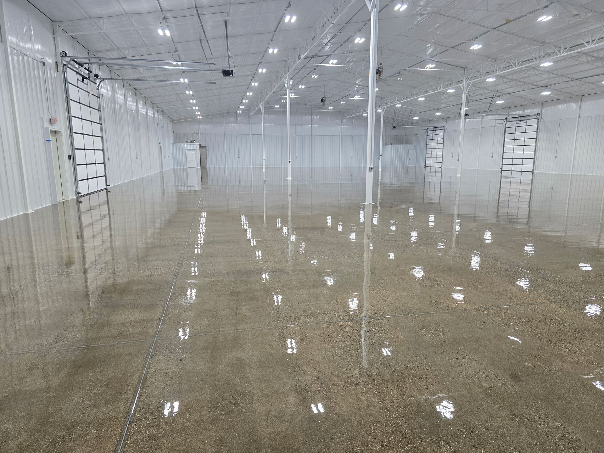 A large concrete floor with a brick wall in the background.