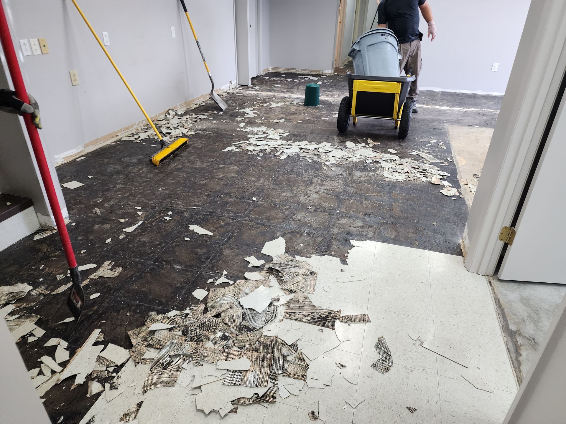 A large concrete floor with a brick wall in the background.