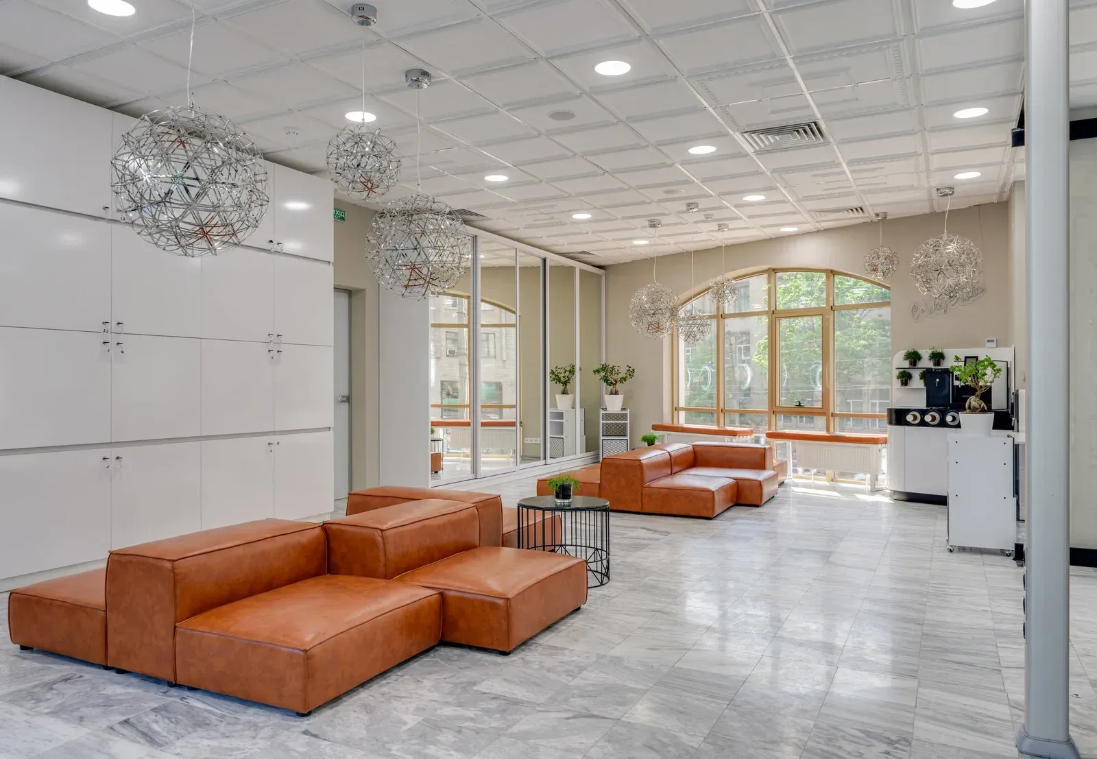 A large room with a lot of furniture and a lot of windows.