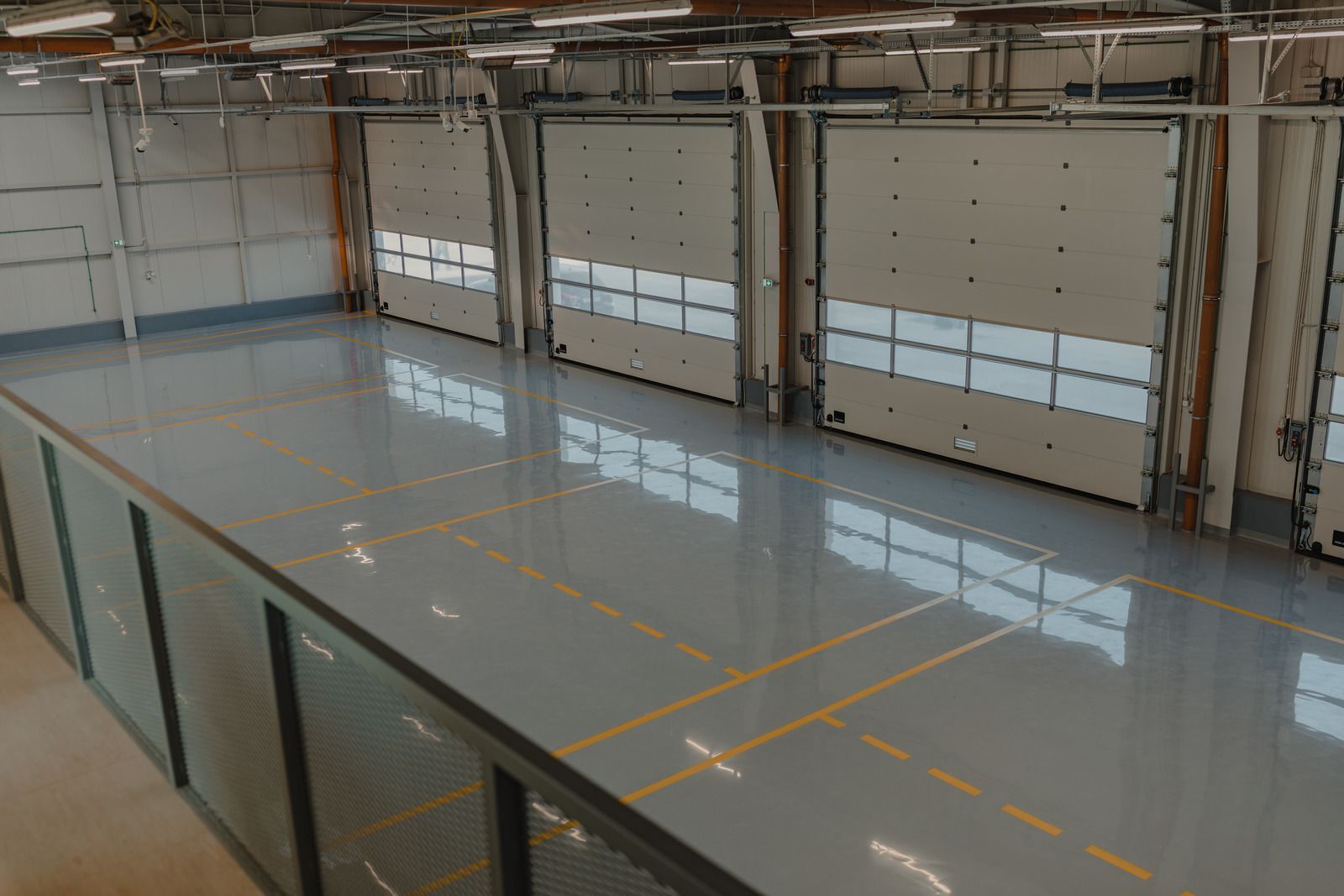 A large room with a shiny concrete floor and a lot of windows.