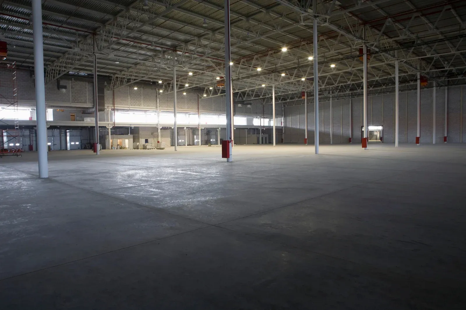 A large room with a lot of furniture and a lot of windows.