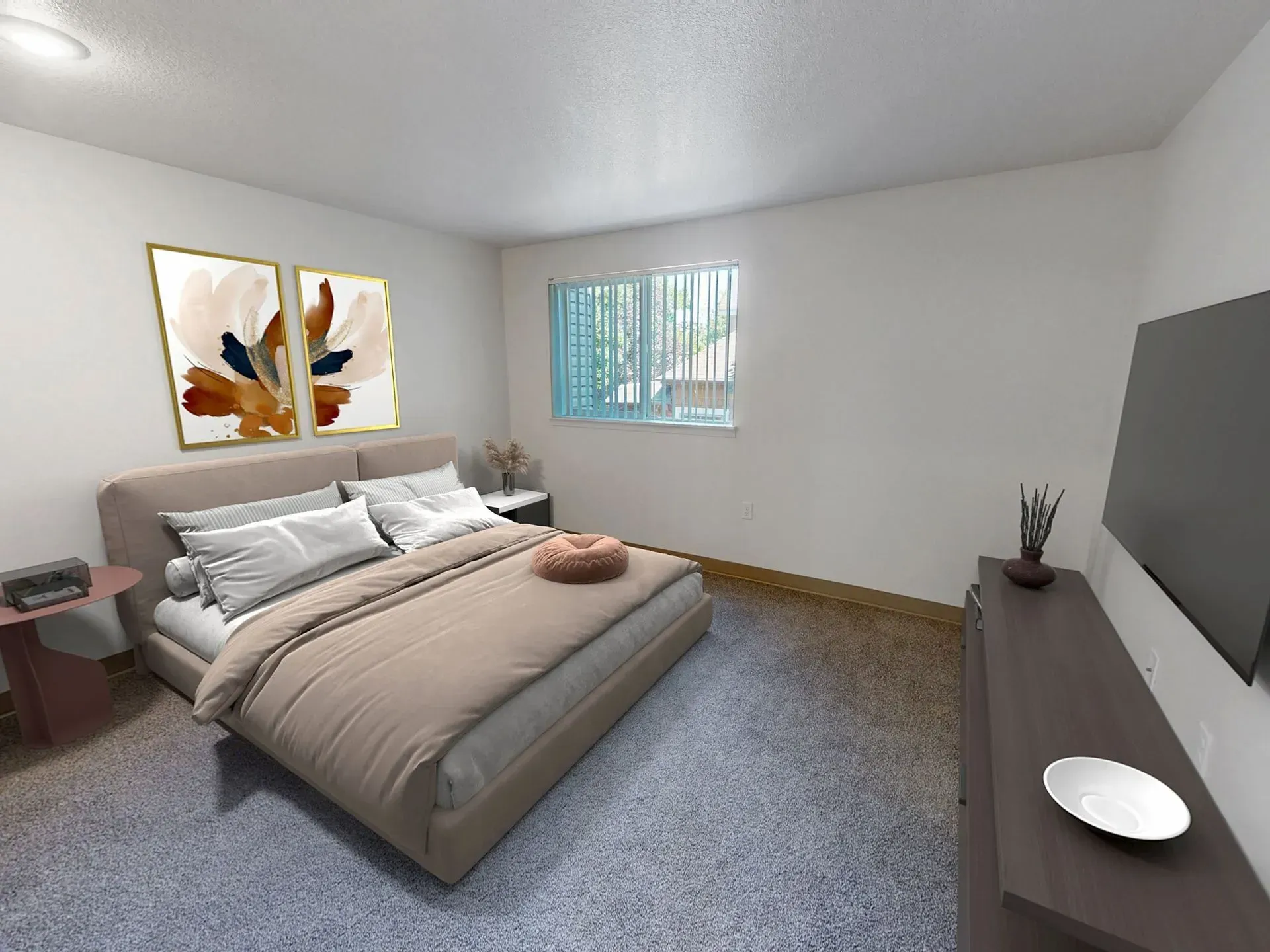 Bedroom with bed, art, TV, and small side tables. Neutral tones, carpeted floor, window with blinds.