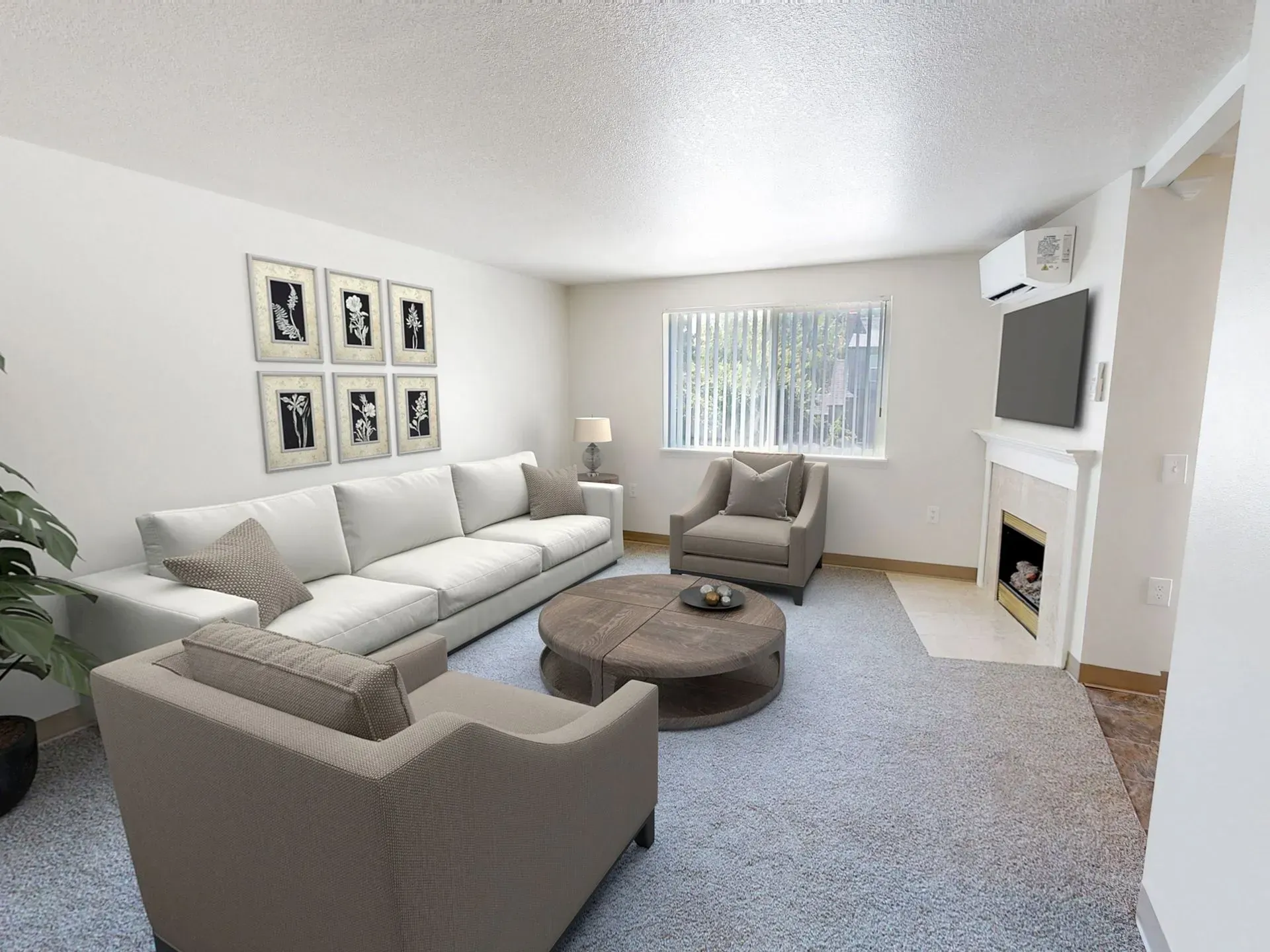 Living room with a sofa, armchairs, coffee table, fireplace, and window with blinds.