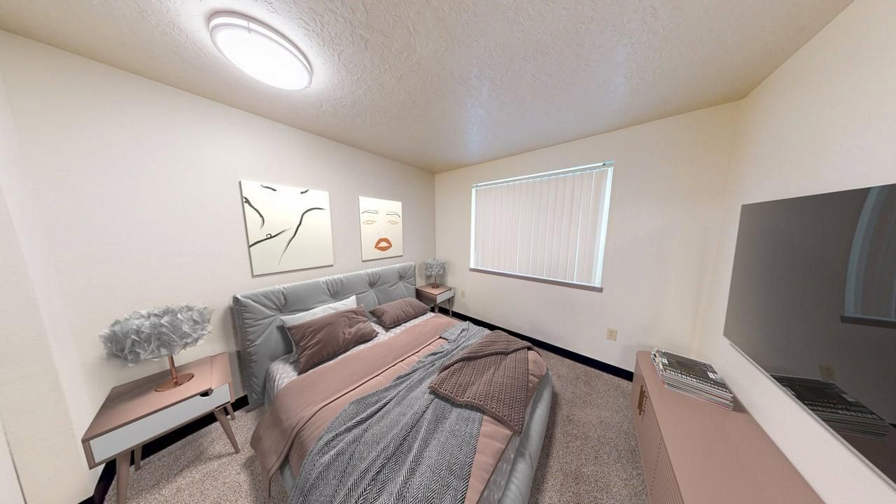 Bedroom with a bed, nightstand, art, window, and TV. Neutral walls and light flooring.