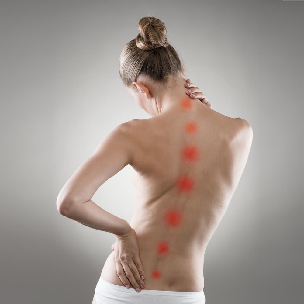 A Woman Is Holding Her Back in Pain — Burwood Back Pain in Strathfield, NSW
