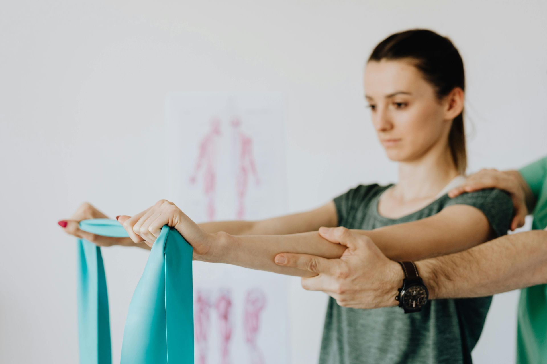 A Woman Is Being Helped by A Man with A Resistance Band — Burwood Back Pain in Strathfield, NSW