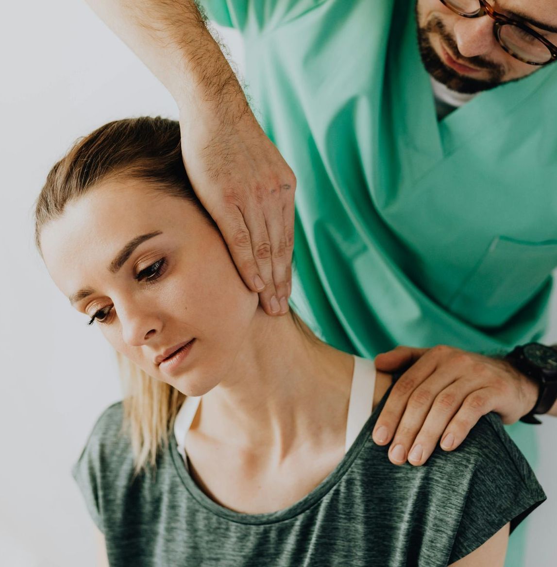A Man Is Giving a Woman a Massage on Her Neck — Burwood Back Pain in Strathfield, NSW
