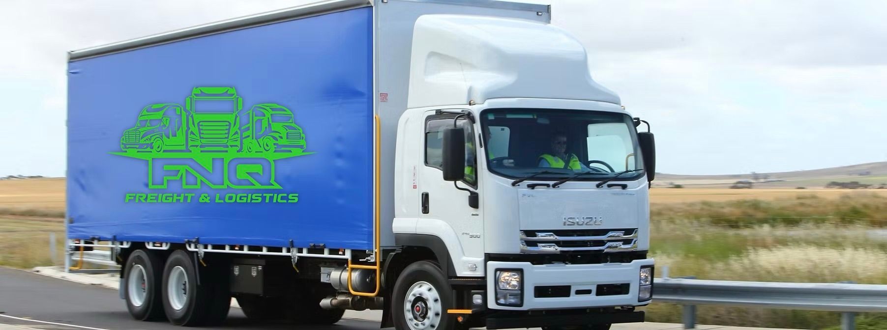 A white and blue FNQ Freight & Logistics truck on a road, blue backdrop.— FNQ Freight & Logistics In Portsmith, QLD