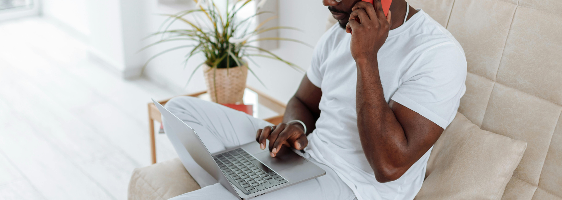 Picture of a man on his laptop at home. 