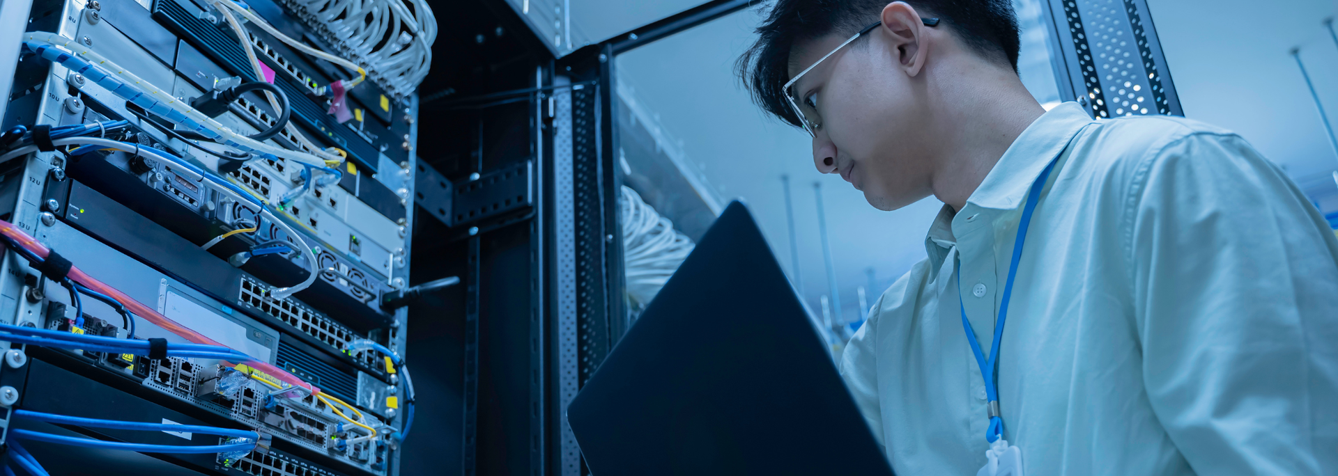 Picture of a man working on a server. 