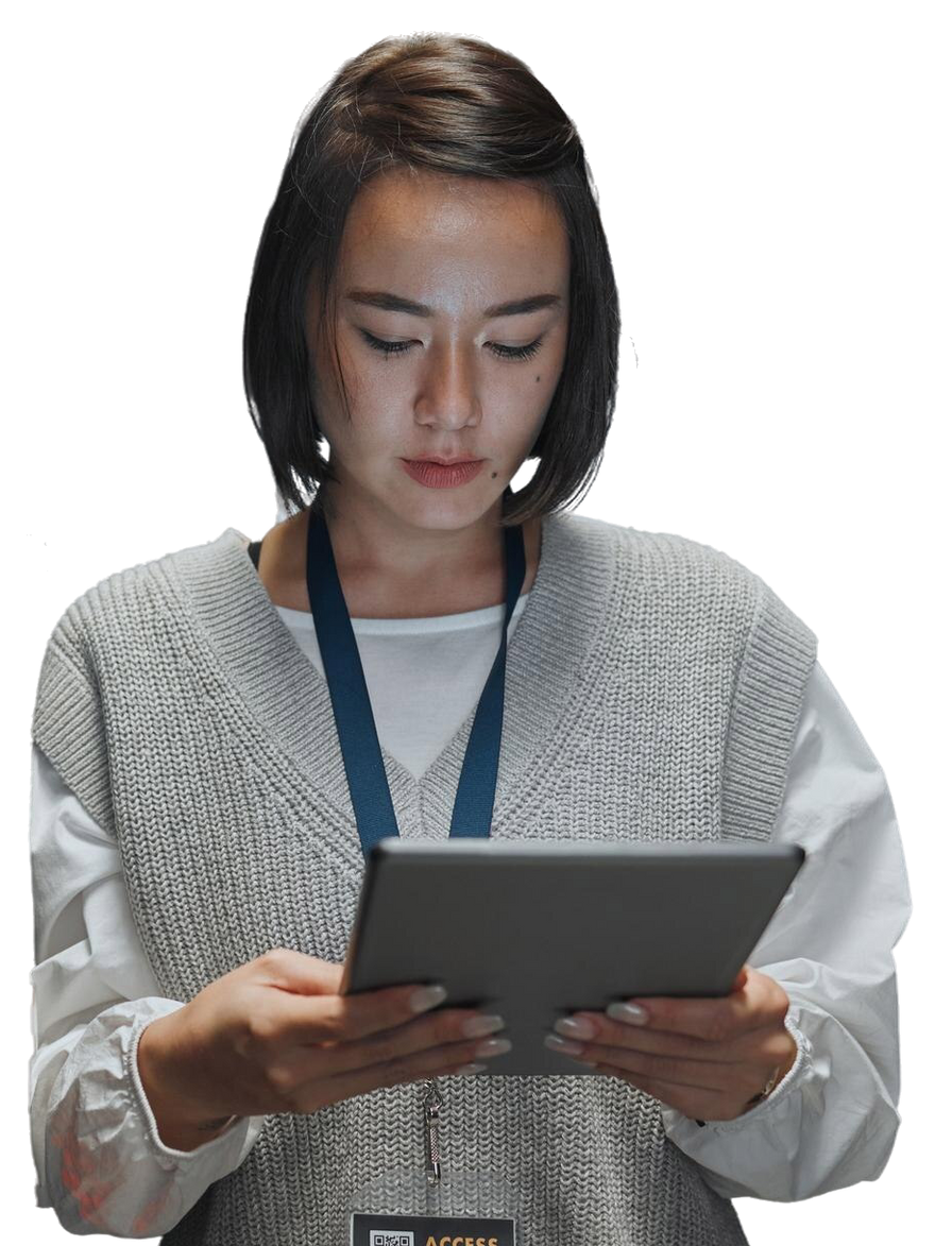 Woman looking at tablet, wearing a sweater and lanyard.