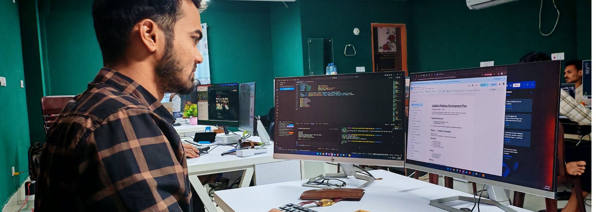Picture of someone sat at a computer coding. 