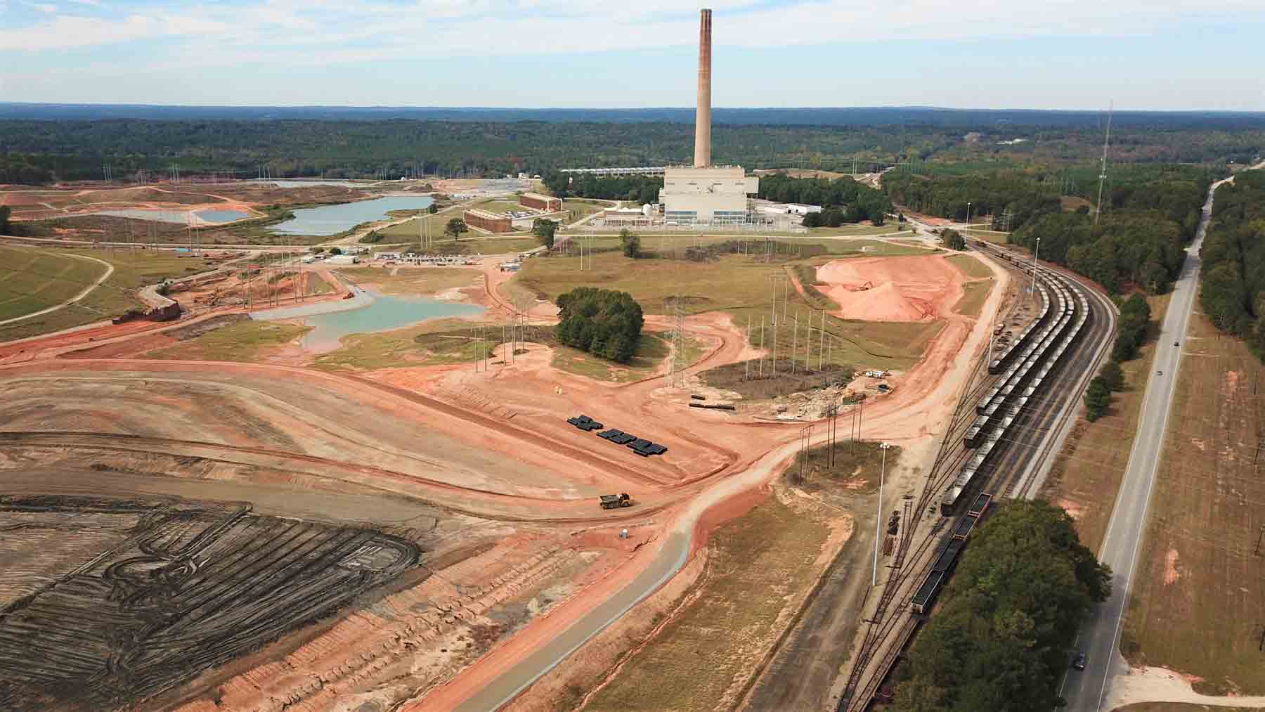 An aerial view of a construction site with a train going by.